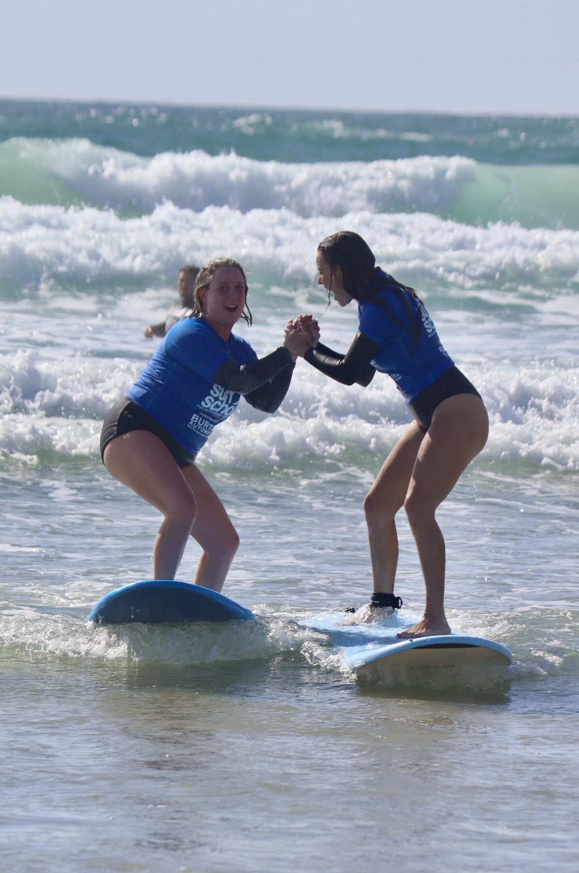 Learner surfer riding a wave at One Mile Beach, Port Stephens